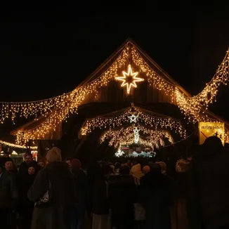 Festlich beleuchteter Weihnachtsmarkt Bremgarten mit leuchtenden Weihnachtssternen, goldenen Lichterketten und zahlreichen Besuchern.
